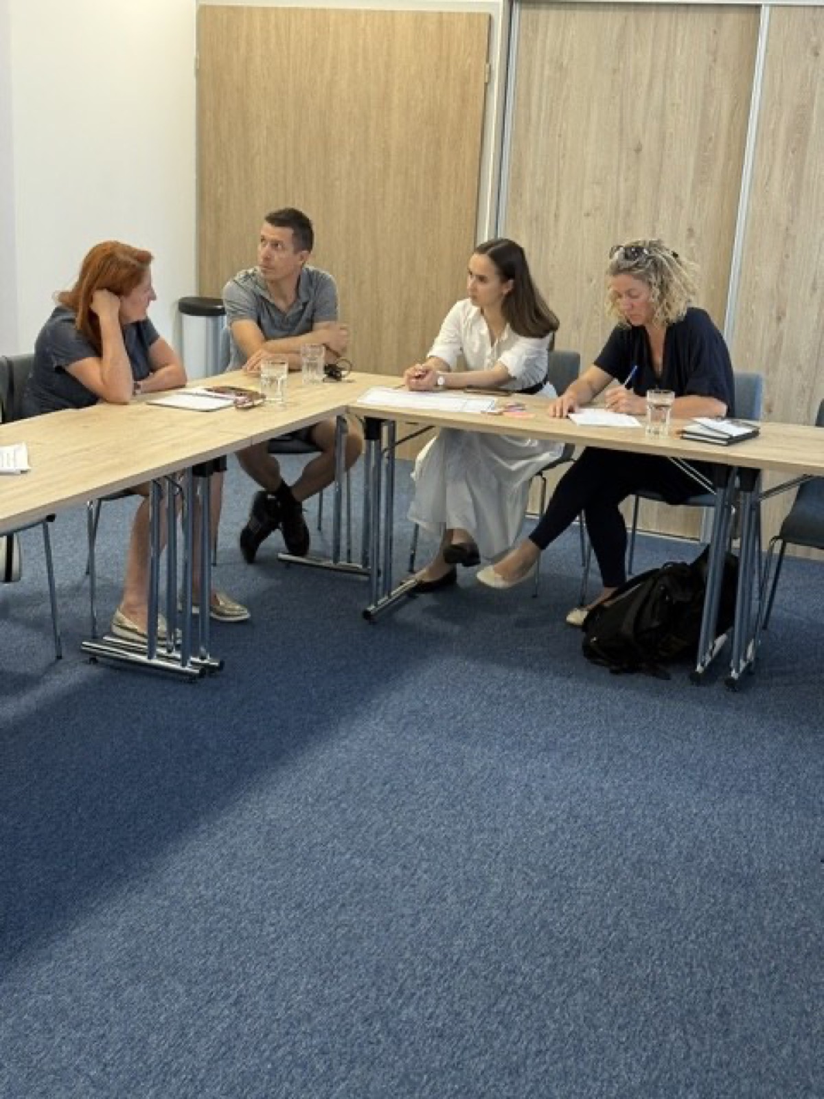 01: Adam Schmutz giving a talk on package pricing at VisitBalaton365's Keszthely training center; in the foreground the “Package creation” canvas with participants' notes. 02: The Keszthely training room with the Lake Balaton map on the wall; participants at the two-day workshop, the title slide on the screen. 03: Small-group work next to the VisitBalaton365 banner and the projected canvas template. 04: Participants following a package example on the projector. 05: The Keszthely training room from above, participants at the U-shaped tables in front of the Lake Balaton map wall. 06: A small group working together on the package canvas. 07: Participants working over the package-planning template at the long table. 08: A lively discussion in a four-person group. 09: Workshop participants in a small-group consultation with notes and a canvas. 10: Participants at the training room table in front of the Lake Balaton map.