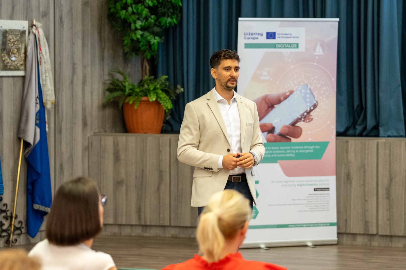 01: The “Digital revolution in tourism” title slide on the screen on the event stage (Hévíz, 2025). 02–06: Adam Schmutz speaking about the digitalization of tourism, next to the DIGITALIZE (Interreg Europe) project banner.