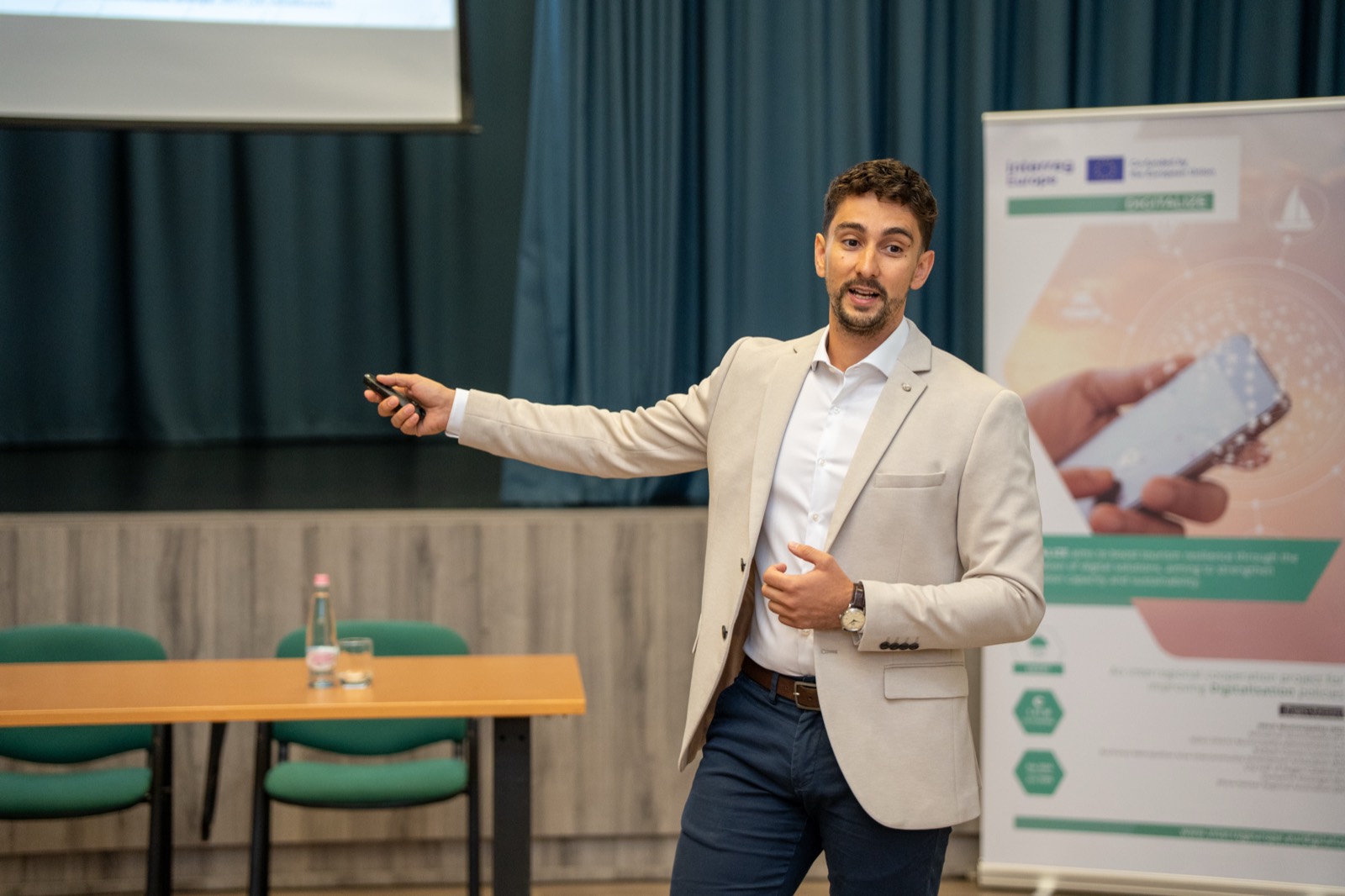 01: The “Digital revolution in tourism” title slide on the screen on the event stage (Hévíz, 2025). 02–06: Adam Schmutz speaking about the digitalization of tourism, next to the DIGITALIZE (Interreg Europe) project banner.