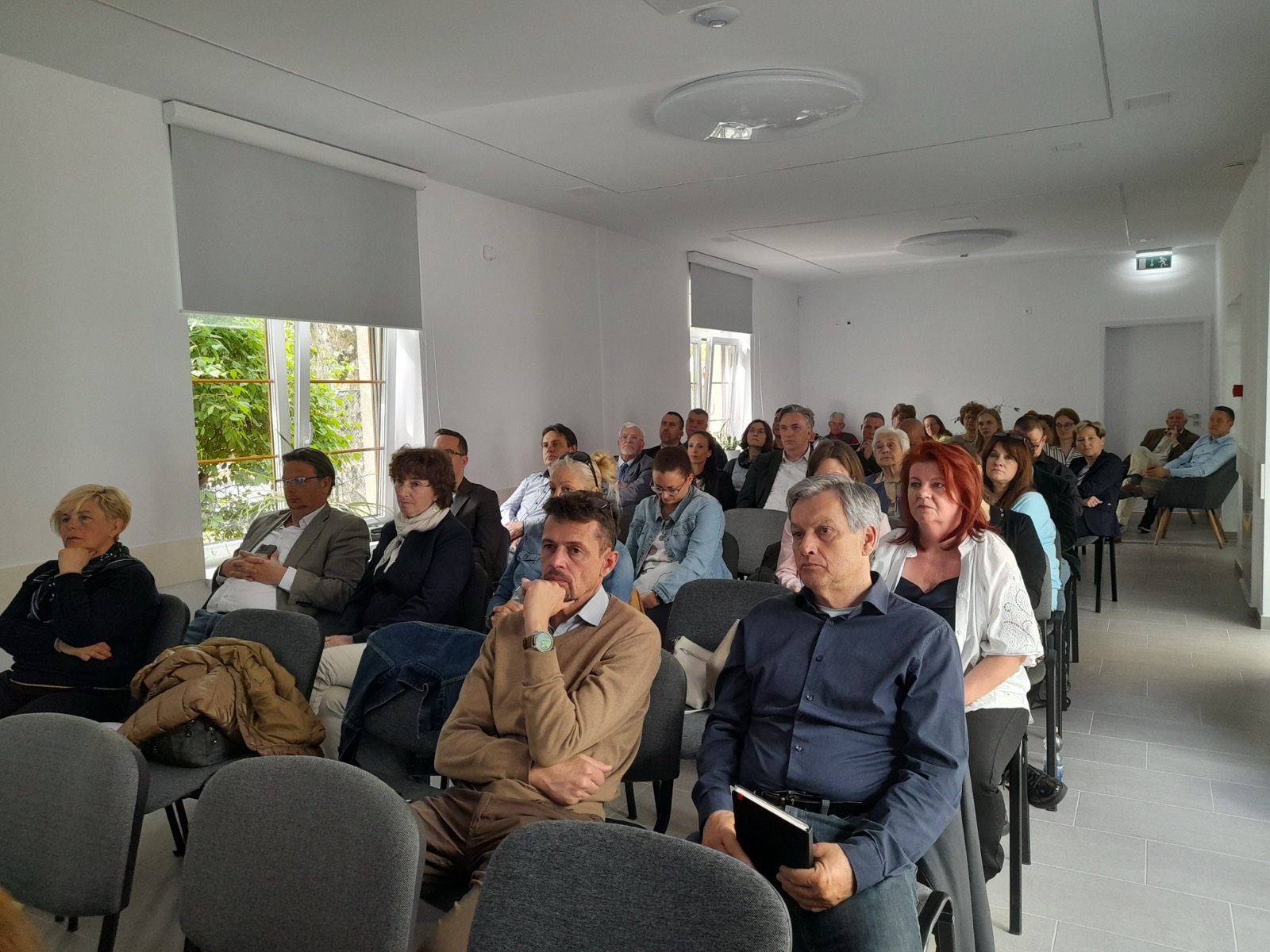 Adam Schmutz speaking at the Earth Day Conference with the “Digitalization ↔ Sustainability” slide (Lake Balaton, 2026) | Adam Schmutz presenting data on sustainability and digitalization trends at the Earth Day Conference | The Earth Day Conference audience during the talk (Smart Tour opening event, Lake Balaton, 2026)